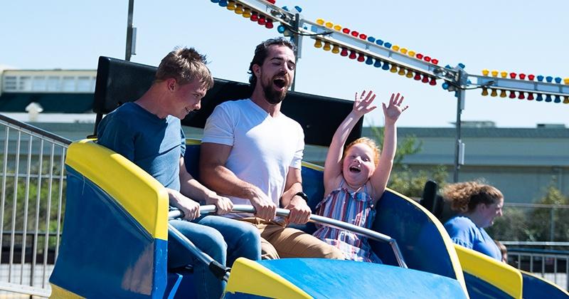 family riding tilt a whirl