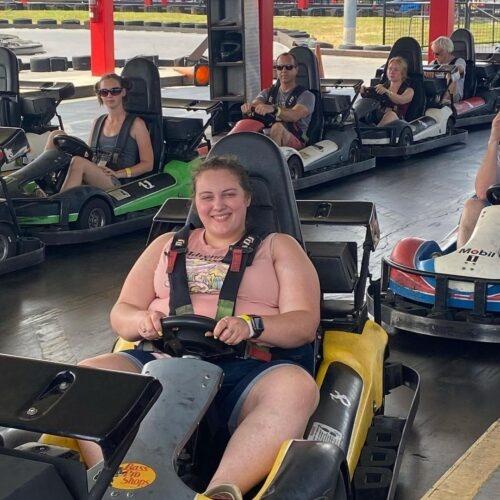 A woman ready to race in a yellow go kart