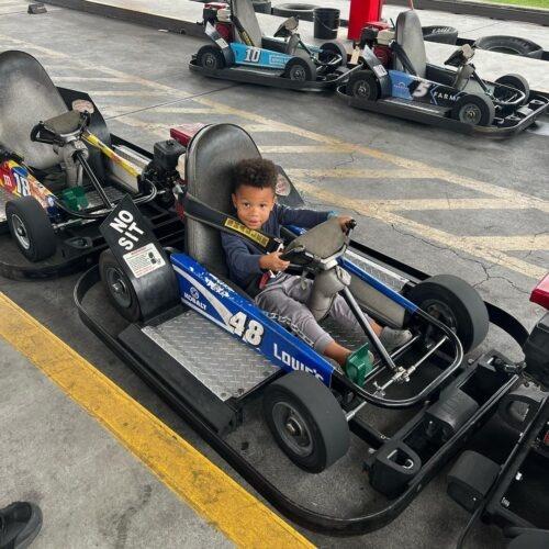 A cute kid ready to in a go-kart