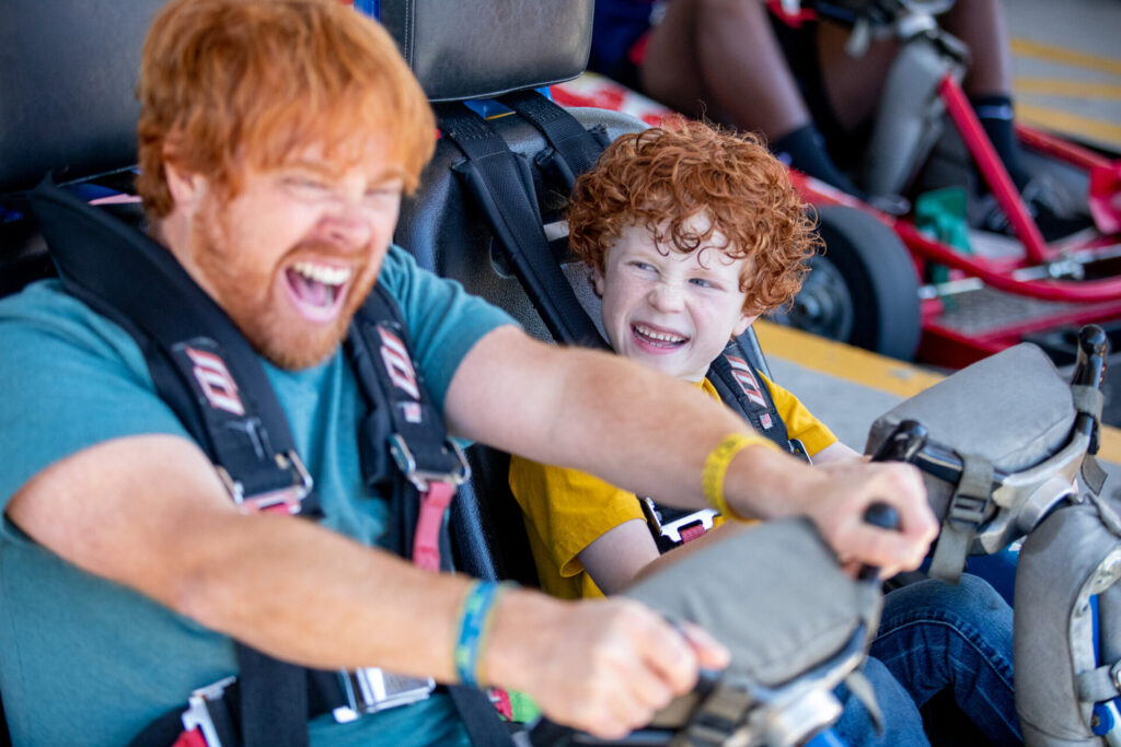 father and son driving a two seated go kart