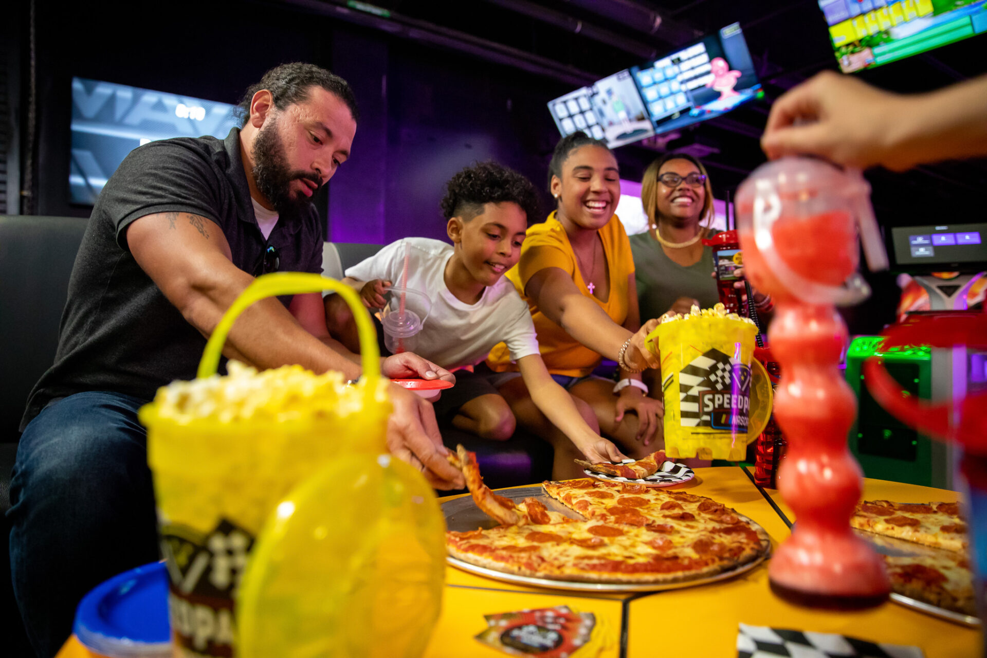 kids and adults eating pizza at a group event